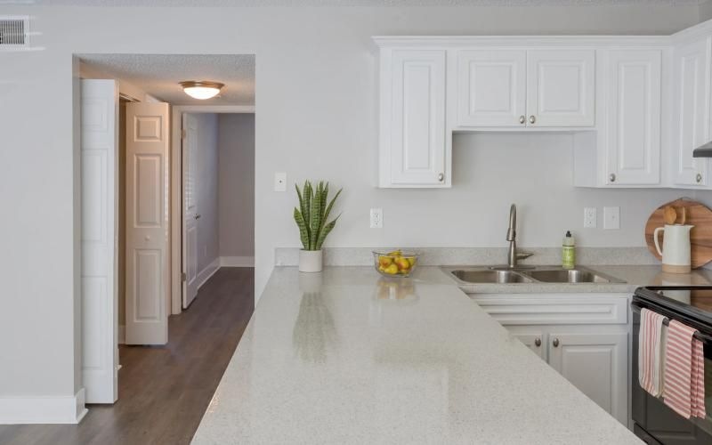 a kitchen with white cabinets