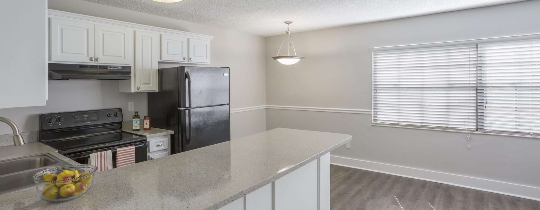 a kitchen with white cabinets