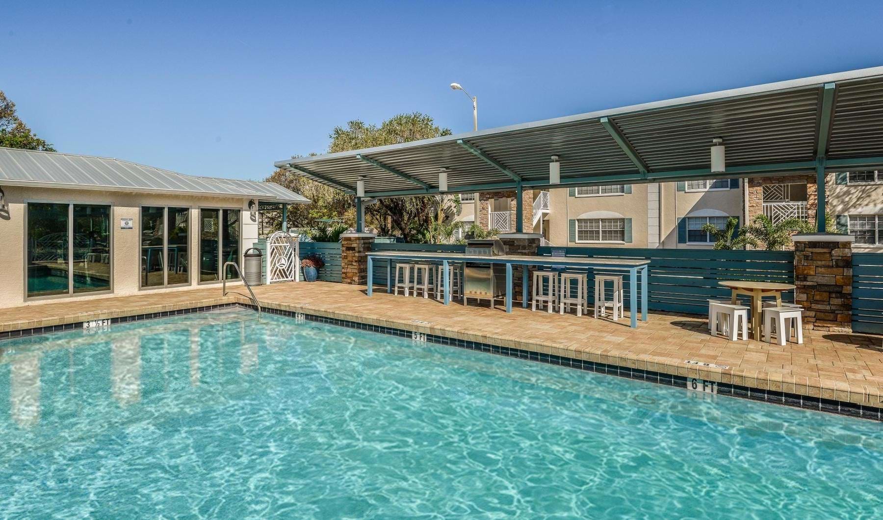 a swimming pool with a tables and chairs